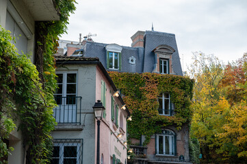 Walking on Montmartre hilly historical artistic district of Paris with famous buildings and narrow streets, tourists destination in France