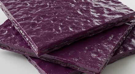 Glossy Aubergine Slabs with a Bumpy, Tactile Surface Stacked Askew.