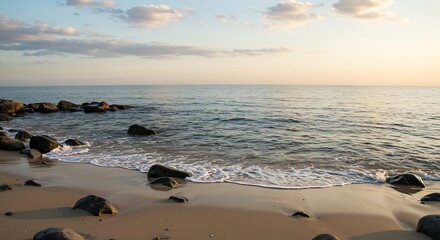 Golden Hour Serenity - Gentle Waves on a Rocky Beach Under a Soft Sky.