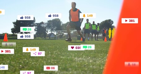 Lunging male athlete wearing orange bib driving on turf field, with cones, dummy, social icons