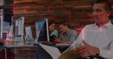 Flipping binder, man in white shirt reviewing notes in open-plan office with DSLR, copy space