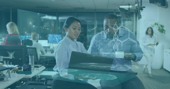 Presenting striped-top woman and blue-shirt colleague reviewing laptop at open office with AR