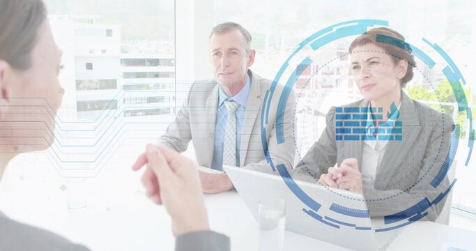 Conducting two suited interviewers holding papers, using laptop at office with blue overlay