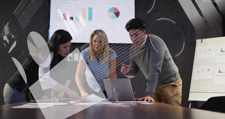 Leaning colleagues in business-casual clothing reviewing laptop and printed charts at meeting table