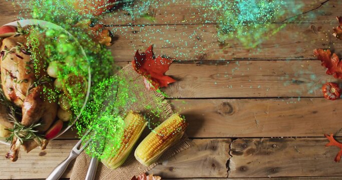 Fototapeta Displaying roasted turkey on platter sitting on wood table with corn, rosemary, glitter, copy space