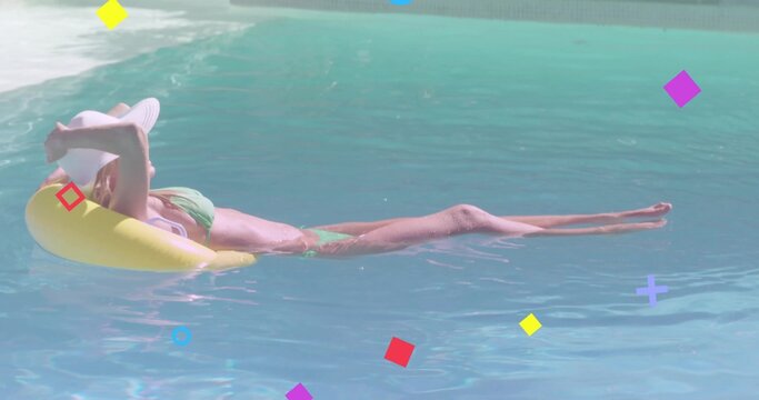 Reclining woman in green bikini, white widebrim hat, floating on yellow ring in pool with overlays