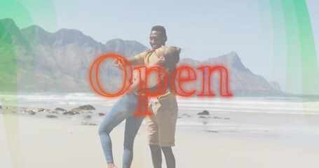 Holding couple hugging on sandy beach, both wearing casual clothes, red Open graphic overlay