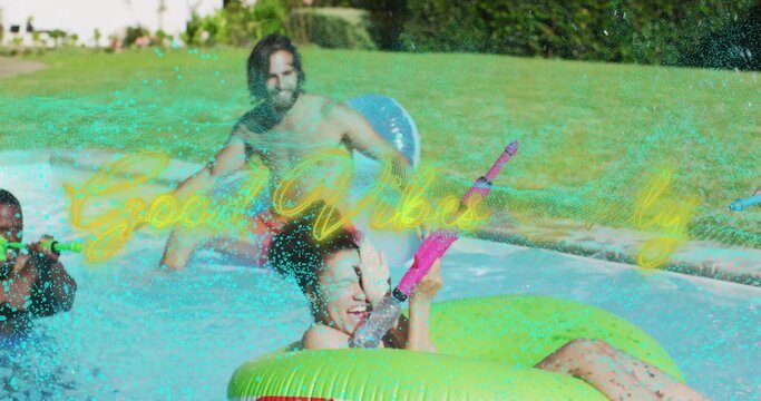 Aiming woman squirting pink water gun in home pool, seated in bright green donut wearing swimsuit