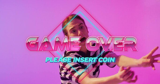 Reaching female model in striped shirt, extending arms in studio with GAME OVER, PLEASE INSERT COIN