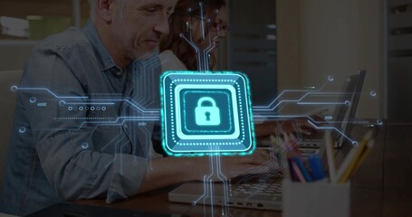 Typing man in denim and woman in glasses at office desk with laptops and padlock overlay
