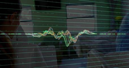 Displaying color chart on glass, tracking trends in dim office with labels and colleagues in shirts