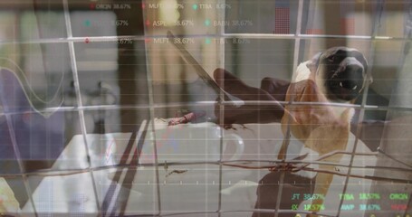 Perching bird on wire mesh at tabletop, opening beak, with mug and reflected charts, copy space © vectorfusionart