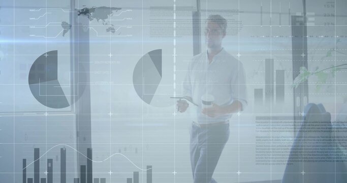 Walking male presenter in business-casual shirt holding coffee cup and remote with charts on glass