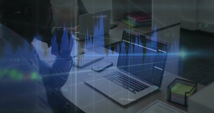 Reviewing coworkers in button-down and blouse analyzing charts at office table, with central laptop - Powered by Adobe