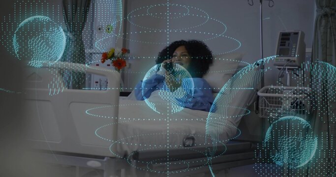 Holding smartphone, patient in light blue gown propped on bed in hospital with teal data rings - Powered by Adobe
