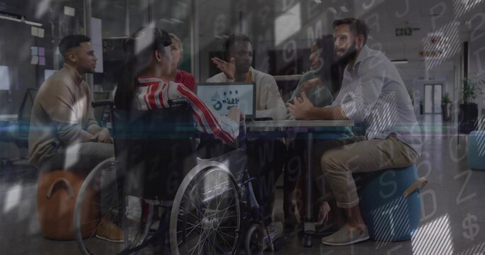 Talking team of six at office table, wheelchair in red jacket, laptop showing charts, code overlay - Powered by Adobe