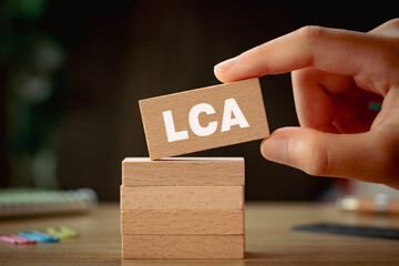 There is wood block with the word LCA. It is an abbreviation for Life Cycle Assessment as eye-catching image.