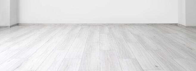 View of empty room with laminate floor and light wall