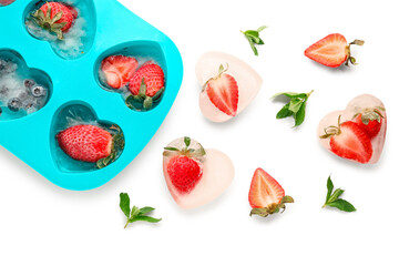 Ice tray with fresh berries frozen in ice on white background
