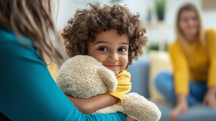 A young child hugging a soft therapy animal as they engage in play therapy, with a warm and supportive therapist beside them, in a room designed for emotional comfort