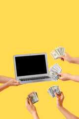 Women with laptop and dollar banknotes on yellow background