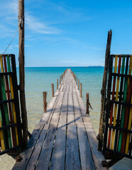 Fototapeta premium Stunning wooden pier leading to the turquoise waters of Koh Kood Island, Thailand