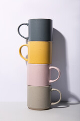 Stack of ceramic mugs on white background