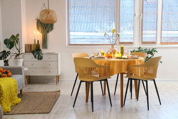 Dining table served with citrus fruits in room
