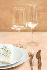 Stylish table setting on beige background. Closeup