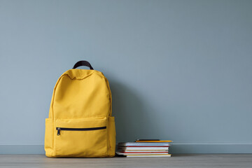 minimalist photograph captures school backpack with open zipper reminding students of forgotten items