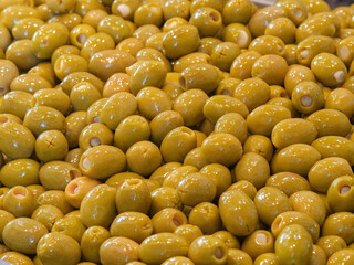 Fresh Green Olives Piled Together at Market Stall
