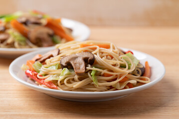 Vegetarian stir fried noodles with mushroom and vegetables with soy sauce, Asian food style