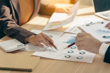 Business people discussing charts and graphs showing results of teamwork in a meeting to analyze financial reports, planning strategies, success.