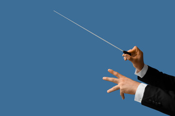 Male conductor's hands on blue background