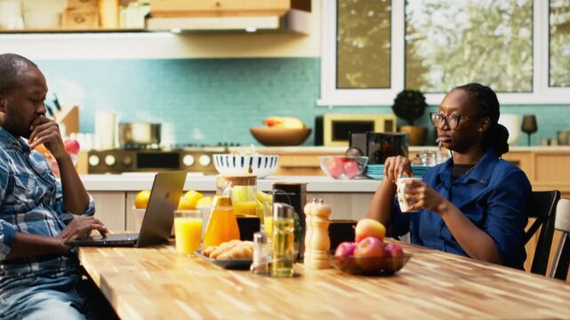 African american guy trying to catch attention of absent zoned out lover, detached woman being defocused and dissociated from her boyfriend over morning coffee. Disconnected girl. Camera B.