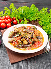Eggplants with champignons in plate on wooden board