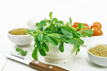 Fenugreek green in mortar on board