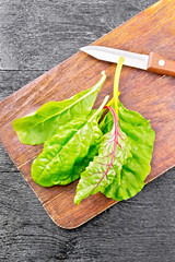 Mangold with knife on dark board top