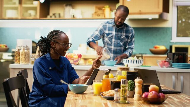 African American man and woman using online retail app for grocery shopping. Selecting and buying products for daily use, ordering perishable and nonperishable items for balanced lifestyle. Camera B.