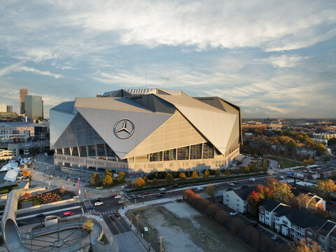 Spectacular aerial drone photo of Mercedes Benz Stadium in Atlanta GA.  Colorful sky and dramatic cityscape give a dynamic aerial image of the modern stadium. 