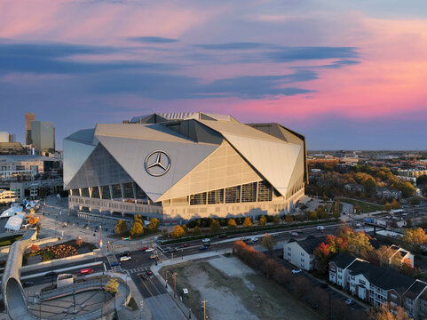 Spectacular aerial drone photo of Mercedes Benz Stadium in Atlanta GA.  Colorful sky and dramatic cityscape give a dynamic aerial image of the modern stadium. 