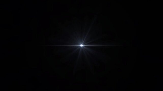A bright lens flare emanating from a single light source in the darkness, representing illumination and cosmic phenomena