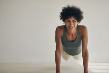 girl performs plank pose with powerful expression on her face showcasing her strength and determination