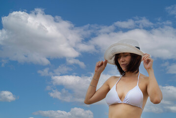 Summer vacations. Lifestyle woman relax and chill on beach background and fashion summer trips walking enjoy tropical beach. Lifestyle and Travel Concept.