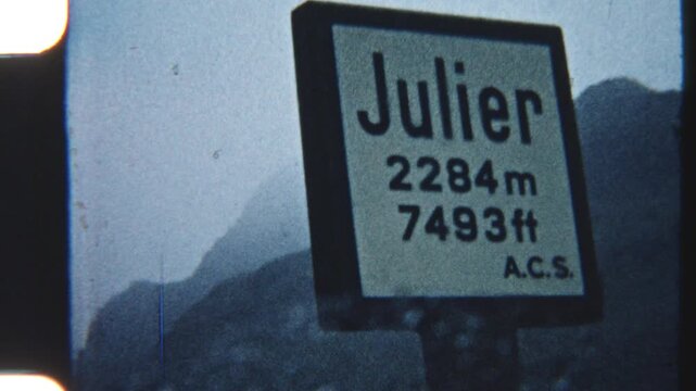 POV From Parked Car With Wiper Moving And Julier Pass Sign Ahead