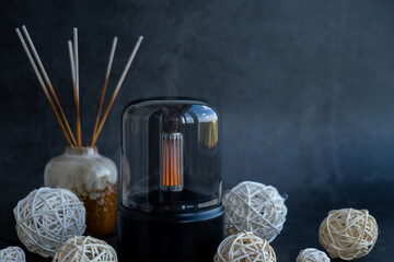 Home fragrance aromatic diffuser with essential oil. Modern air humidifier at home. Improving the comfort of wellbeing living in house. Ultrasonic aroma perfume steam technology