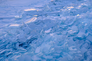 Endless hummock field on frozen Lake Baikal. Piles of snow-covered debris of blue ice on frosty day