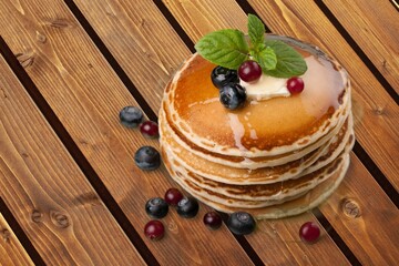 Crepes, tasty pancakes on plate with berries