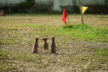 wooden bottle for petanque sport Thai style, equipment on green grass