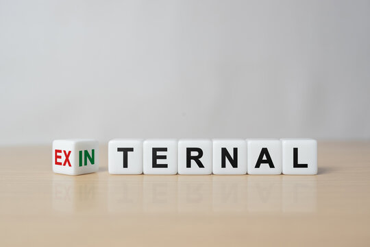 Cubes, dice or blocks showing the words external and internal on wooden background